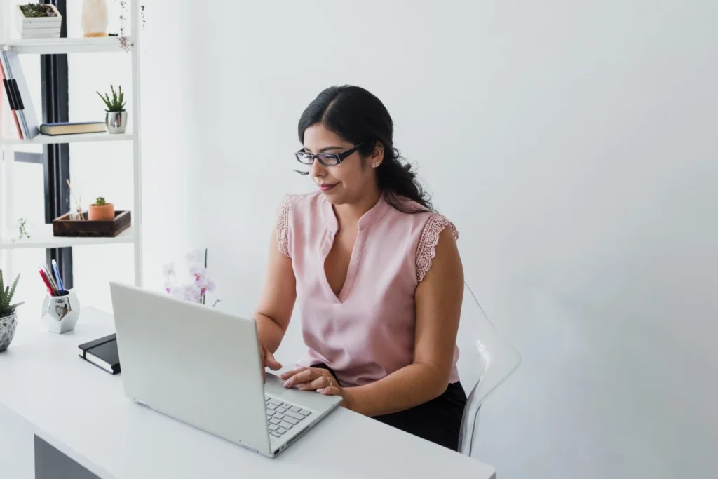 Woman typing on laptop at desk